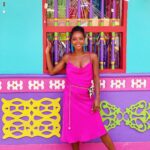 Jewels standing in front of colorful building in Guatape