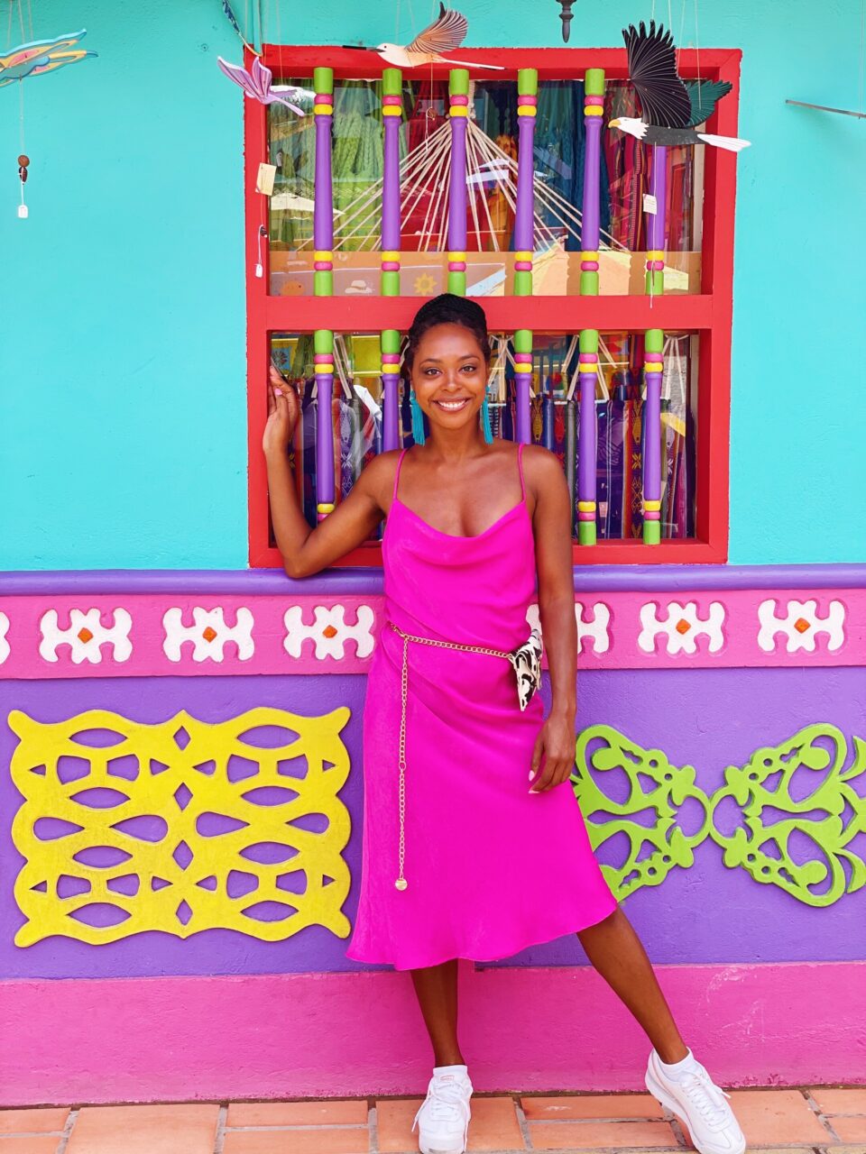 Jewels standing in front of colorful building in Guatape