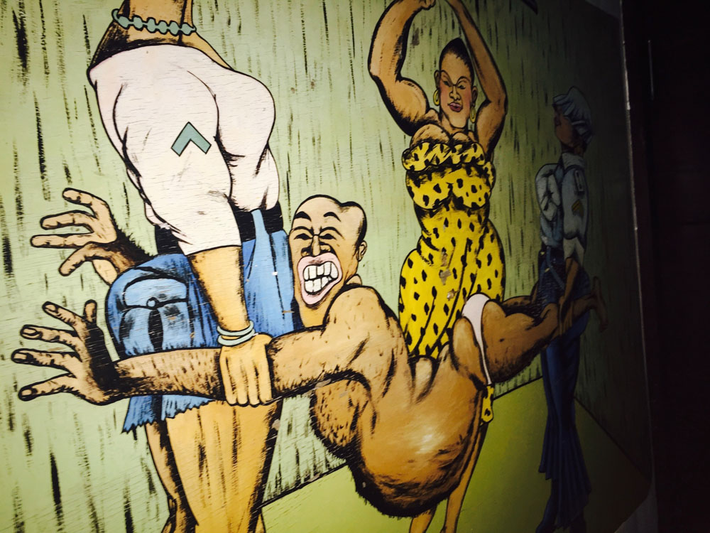 Artwork in Firefly Lounge of two women holding a man