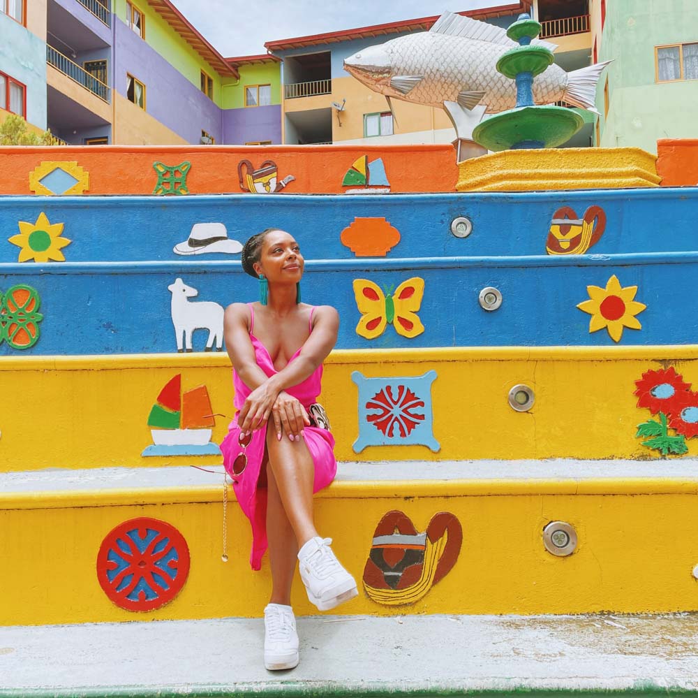 Jewels sitting on colorful stairs in Guatape
