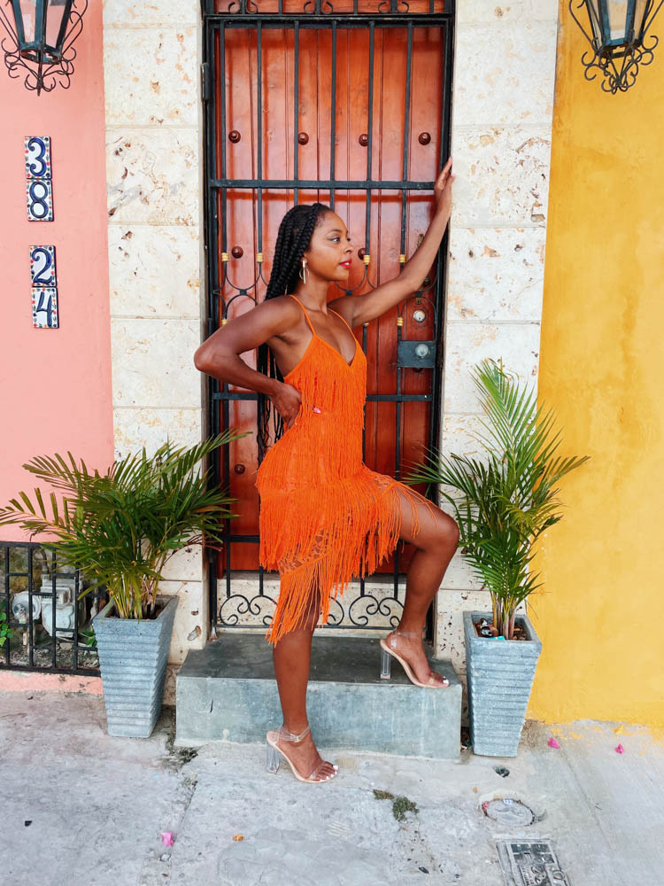 Jewels standing in front of colorful building in Colombia